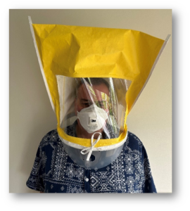 Person with hood and respirator 